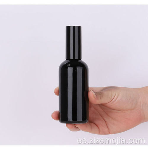 Botella de espray de cristal negra vacía con bomba